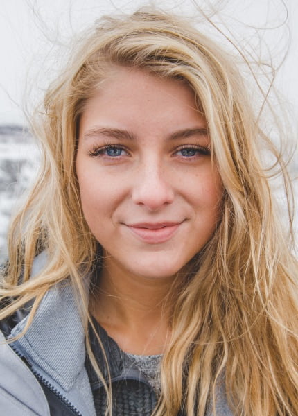 Headshot of a young, blond woman looking into the camera
